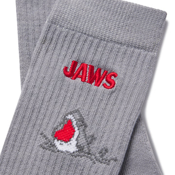 closeup image of Gray socks with 'JAWS' embroidery on a light gray background